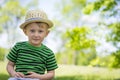 Young boy wearing a fedora at the park