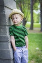 Young boy wearing a fedora at the park