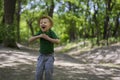 Young boy wearing a fedora at the park