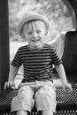 Young boy wearing a fedora at the park