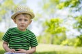 Young boy wearing a fedora at the park
