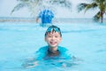 Young boy wearing goggles swimming in swimming pool Royalty Free Stock Photo
