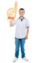 Young boy wearing a large foam hand