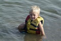 young boy wearing life jacket in the water Royalty Free Stock Photo