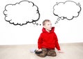 Young boy wearing red hoodie is daydreaming thinking about something, text cloud with space for your text Royalty Free Stock Photo