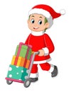 Young boy wearing santa claus costume carrying a gifts in trolley pushcart
