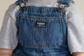 A young boy wears overalls