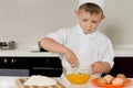 Young boy whisking eggs with a fork Royalty Free Stock Photo