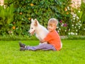 Young boy and White Swiss Shepherd`s puppy Royalty Free Stock Photo