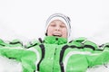 Young boy in winter snow laughing with enjoyment Royalty Free Stock Photo