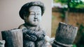 Young boy wooden sculpture on blurred background