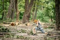Young boy in the woods in a clearing with a wooden stick Royalty Free Stock Photo