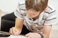 Young boy working on a school project at home Royalty Free Stock Photo