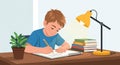 A young boy is writing in a notebook at a desk, using a pencil. He\'s wearing a blue Royalty Free Stock Photo