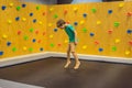 Young Boy 6 year old Jumping on a trampoline in children fitness gym Royalty Free Stock Photo