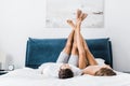 Young boyfriend and girlfriend lying with raised legs
