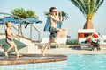 Young boys with bare torsos jumping into swimming pool