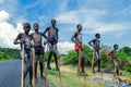 Young Boys of Benna Tribe with Traditional Body Painting on the Long Wooden Sticks posing for the picture