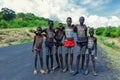 Young Boys of Benna Tribe with Traditional Body Painting on the Long Wooden Sticks posing for the picture