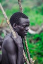 Young Boys of Benna Tribe with Traditional Body Painting on the Long Wooden Sticks posing for the picture Royalty Free Stock Photo