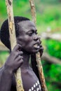 Young Boys of Benna Tribe with Traditional Body Painting on the Long Wooden Sticks posing for the picture Royalty Free Stock Photo