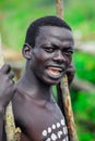 Young Boys of Benna Tribe with Traditional Body Painting on the Long Wooden Sticks posing for the picture Royalty Free Stock Photo