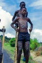 Young Boys of Benna Tribe with Traditional Body Painting on the Long Wooden Sticks posing for the picture Royalty Free Stock Photo