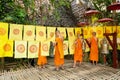 Young boys in Buddhist monastery decorated garden by flags with religious symbols