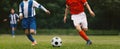 Young Boys Compete in Tournament Match in a Duel. Football Game on Summer Sunny Day