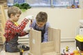 Young boys construct wooden stool Royalty Free Stock Photo