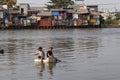 Young boys fishing in polluted river