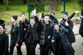 Young boys and girls masked as mimes participate in the masquerade