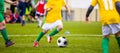 Young boys kicking soccer football on the sports field Royalty Free Stock Photo