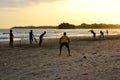 Young boys playing cricket game on a beach