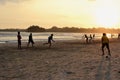 Young boys playing cricket game on a beach