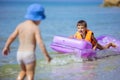 Young boys playing with floating air mattress Royalty Free Stock Photo