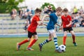 Young boys playing a football game. Training and soccer match between youth school teams Royalty Free Stock Photo