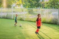 Young boys playing football soccer game. Running players in uniforms Royalty Free Stock Photo