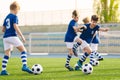 Young boys playing football training game. Happy children kicking soccer balls on practice pitch Royalty Free Stock Photo