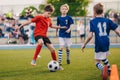 Young boys playing soccer game. Training and football match between youth soccer teams Royalty Free Stock Photo