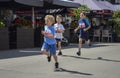 Young boys racing on the city street during the children running competition Royalty Free Stock Photo