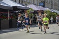 Young boys racing on the city street during the children running competition Royalty Free Stock Photo