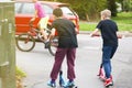 Young boys riding happily on the scooter, photographed from behind. Hollidays, summer vacation.