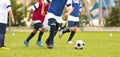 Young Boys Running During Football Training. Players in Training Unifrms Compete in Training Match