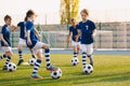 Young Boys of Sports Club on Soccer Football Training. Kids Improving Soccer Skills on Natural Turf Grass Pitch