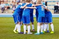 Young boys sports team on stadium. Football players in sportswear motivating before the match