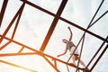 Young brave man balancing on the top of high metal construction