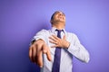 Young brazilian businessman wearing elegant tie standing over isolated purple background laughing at you, pointing finger to the Royalty Free Stock Photo