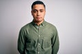 Young brazilian man wearing casual shirt standing over isolated white background depressed and worry for distress, crying angry Royalty Free Stock Photo