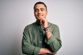 Young brazilian man wearing casual shirt standing over isolated white background looking confident at the camera with smile with Royalty Free Stock Photo